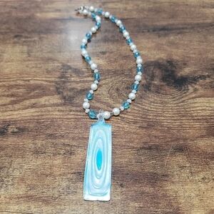 blue beaded statement necklace with glass pendant